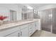 Bright bathroom featuring a double vanity with granite countertops, a glass enclosed shower and ample storage at 5107 Coral Reef Way, Bradenton, FL 34211