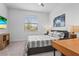 Cozy bedroom featuring a ceiling fan and a window with blinds, complemented by a desk and stylish decor at 5107 Coral Reef Way, Bradenton, FL 34211