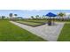 Bocce ball courts with artificial turf surfaces, wooden borders, shade covers, and brick-paved walkways at 5107 Coral Reef Way, Bradenton, FL 34211