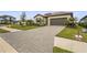Paver driveway leading to a well-maintained home, complemented by a lush green lawn at 5107 Coral Reef Way, Bradenton, FL 34211