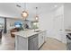 Modern kitchen island with stainless steel appliances and pendant lighting overlooking the living area at 5107 Coral Reef Way, Bradenton, FL 34211