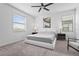 Bright main bedroom with plush carpeting, featuring an oversized window for natural light and minimalistic decor at 5107 Coral Reef Way, Bradenton, FL 34211