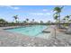Resort-style pool with multiple lounge chairs for relaxing by the pool and palm trees at 5107 Coral Reef Way, Bradenton, FL 34211