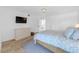 Spacious bedroom with dresser and light wood floors at 5635 Gulf Of Mexico Dr # 103, Longboat Key, FL 34228