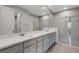 This bathroom features a double vanity, quartz countertop, and tiled shower with glass door at 5658 Silverbridge Trl, Bradenton, FL 34211