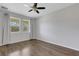 Bright bedroom with wood-look flooring and neutral walls is bathed in natural light at 5658 Silverbridge Trl, Bradenton, FL 34211