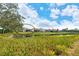 Backyard view of homes along the pond showing their screened lanais at 6504 Copper Ridge Trl, Bradenton, FL 34201