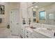 Bright bathroom with double sink vanity, large mirror, tub, and plenty of cabinet space at 6504 Copper Ridge Trl, Bradenton, FL 34201