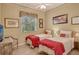 Guest bedroom with two twin beds and red bedding at 6504 Copper Ridge Trl, Bradenton, FL 34201