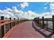 A scenic curved wooden bridge overlooks a calm lake at 6504 Copper Ridge Trl, Bradenton, FL 34201