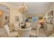 Dining room with chandelier, light walls and view into living room with ample natural light at 6504 Copper Ridge Trl, Bradenton, FL 34201