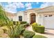 Home's exterior entrance with well-manicured landscaping and walkway at 6504 Copper Ridge Trl, Bradenton, FL 34201