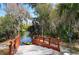 Steps lead down to a kayak launch on a calm waterway, surrounded by lush greenery at 6504 Copper Ridge Trl, Bradenton, FL 34201