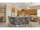 Open kitchen with a breakfast bar featuring seating for four, and light wood cabinets at 6504 Copper Ridge Trl, Bradenton, FL 34201