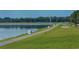 Paved trail meanders along a lake, offering scenic views at 6504 Copper Ridge Trl, Bradenton, FL 34201