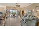 Bright living room featuring neutral tile flooring and sliding glass doors to the outdoor living area at 6504 Copper Ridge Trl, Bradenton, FL 34201
