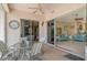 Covered patio with glass doors leading to the living room and a seating area at 6504 Copper Ridge Trl, Bradenton, FL 34201
