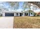 Newly renovated white brick home with a gray garage door and paved driveway at 6805 13Th W Ave, Bradenton, FL 34209