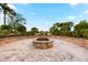 Community fire pit with brick seating at 8721 Bellussi Dr, Sarasota, FL 34238