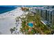 Aerial view of condo building, pool, and beach, showing its prime location at 915 Seaside Dr # 604, Sarasota, FL 34242