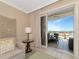 Balcony view from the living room, with outdoor seating and a neighborhood view at 915 Seaside Dr # 604, Sarasota, FL 34242