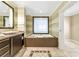 Spa-like bathroom featuring a large soaking tub and double vanity at 915 Seaside Dr # 604, Sarasota, FL 34242