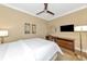 Spacious bedroom with king-size bed, ceiling fan, and mounted TV at 915 Seaside Dr # 604, Sarasota, FL 34242