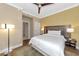 King-size bed, ceiling fan, and large TV in comfortable bedroom at 915 Seaside Dr # 604, Sarasota, FL 34242
