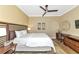 Comfortable bedroom with king-size bed, ceiling fan, and workspace at 915 Seaside Dr # 604, Sarasota, FL 34242