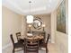 Elegant dining area with glass table and four chairs at 915 Seaside Dr # 604, Sarasota, FL 34242