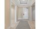 Well-lit hallway featuring neutral paint colors and tile flooring at 915 Seaside Dr # 604, Sarasota, FL 34242