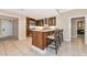 Eat-in kitchen with stainless steel appliances, white countertops, tile flooring, and three barstools at 915 Seaside Dr # 604, Sarasota, FL 34242