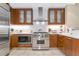 Modern kitchen featuring stainless steel appliances, wooden cabinets, and white countertops at 915 Seaside Dr # 604, Sarasota, FL 34242