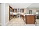 Spacious kitchen featuring stainless steel appliances, custom cabinets, and island seating at 915 Seaside Dr # 604, Sarasota, FL 34242