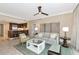 Open concept living room with tile floors, ceiling fan, comfortable seating and kitchen access at 915 Seaside Dr # 604, Sarasota, FL 34242