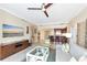 Cozy living room with a ceiling fan, tile floors, comfortable seating, and kitchen access at 915 Seaside Dr # 604, Sarasota, FL 34242