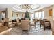 Community lounge with tables, chairs, and a large chandelier at 915 Seaside Dr # 604, Sarasota, FL 34242