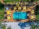 Aerial view of the pool shows the layout of chairs, umbrellas, and landscaping at 915 Seaside Dr # 604, Sarasota, FL 34242