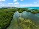 Aerial view of property with lush landscape and waterways at 9397 Midnight Pass Rd # 906, Sarasota, FL 34242