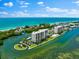 Aerial view of beachfront property with resort amenities at 9397 Midnight Pass Rd # 906, Sarasota, FL 34242
