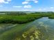 Aerial view of property showing lush landscape, waterways, and kayaks at 9397 Midnight Pass Rd # 906, Sarasota, FL 34242