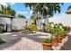 Outdoor kitchen and dining area with grill, picnic table, and lush landscaping at 9397 Midnight Pass Rd # 906, Sarasota, FL 34242