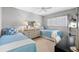 Well-lit bedroom with twin beds, dresser, and desk at 9397 Midnight Pass Rd # 906, Sarasota, FL 34242