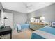 Well-lit bedroom with twin beds, dresser, and desk at 9397 Midnight Pass Rd # 906, Sarasota, FL 34242