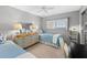 Well-lit bedroom with twin beds, dresser, and desk at 9397 Midnight Pass Rd # 906, Sarasota, FL 34242