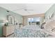 Bright bedroom with a queen bed and water view at 9397 Midnight Pass Rd # 906, Sarasota, FL 34242