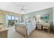 Bright bedroom with a queen bed and water view at 9397 Midnight Pass Rd # 906, Sarasota, FL 34242