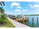 Private boat dock with two boats and calm water views at 9397 Midnight Pass Rd # 906, Sarasota, FL 34242