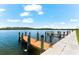 Community dock with wooden planks and multiple boat slips at 9397 Midnight Pass Rd # 906, Sarasota, FL 34242