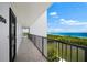 Hallway with ocean view, leading to condo unit at 9397 Midnight Pass Rd # 906, Sarasota, FL 34242